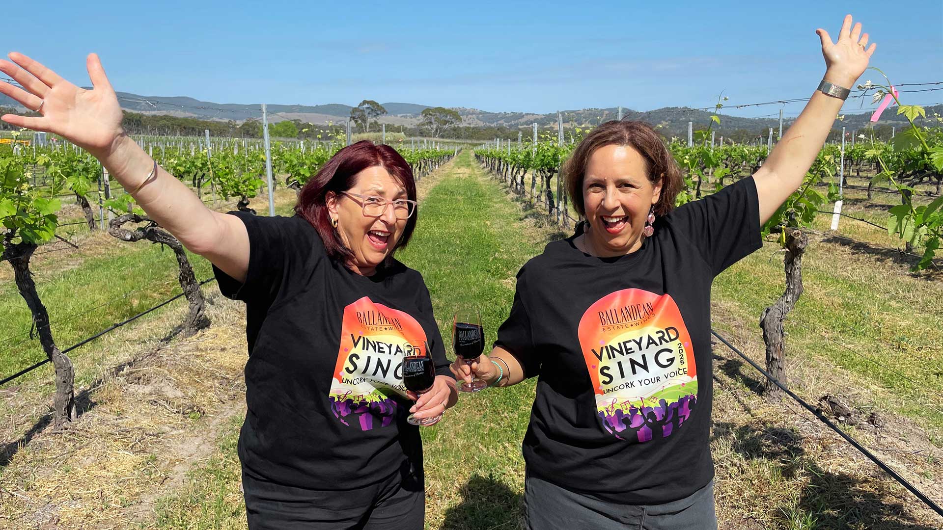 two women excited in vineyard