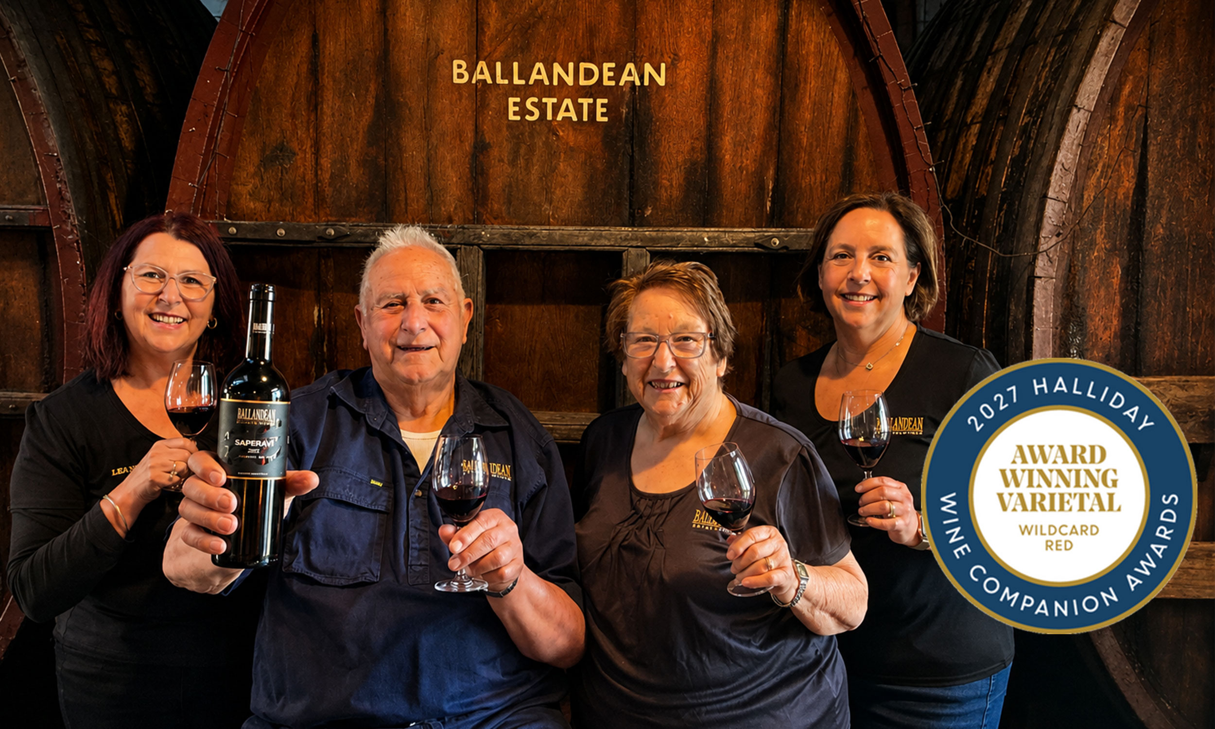 Family photo two brunette sisters with their parents drinking glasses of Saperavi in front of wine barrels